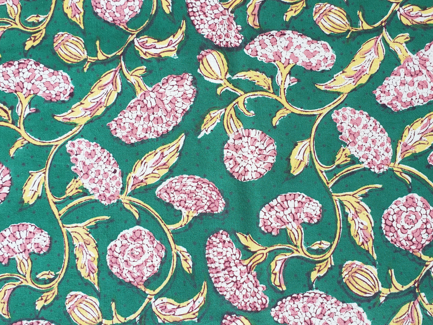 Detalle de estampado de sobrecama 100% algodón estampado a mano, base verde obscuro con flores rosas. Hecho en la India.