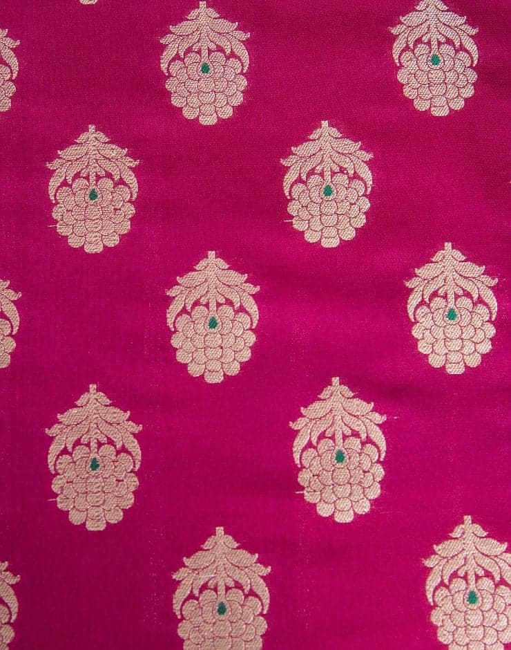 Camino de mesa en seda fuschia con flores entretejidas con hilo dorado y pequeños detalles en turquesa.